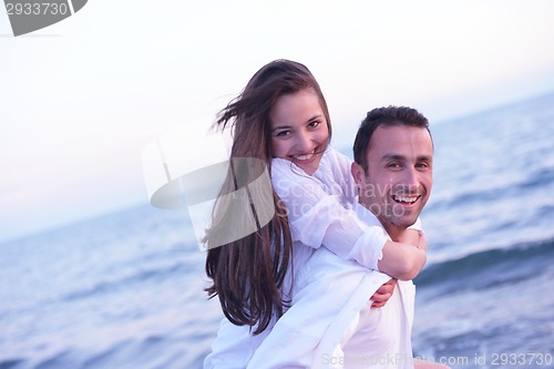 Image of young couple  on beach have fun