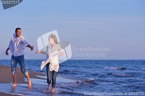 Image of young couple  on beach have fun