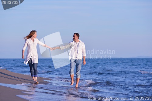 Image of young couple  on beach have fun