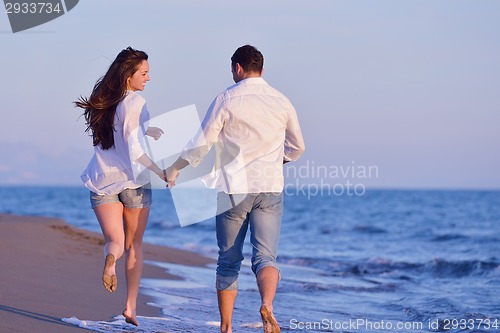 Image of young couple  on beach have fun