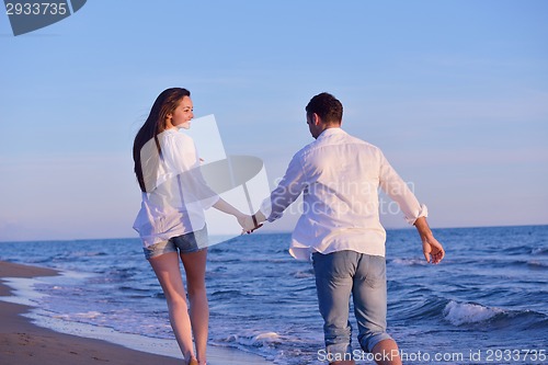 Image of young couple  on beach have fun