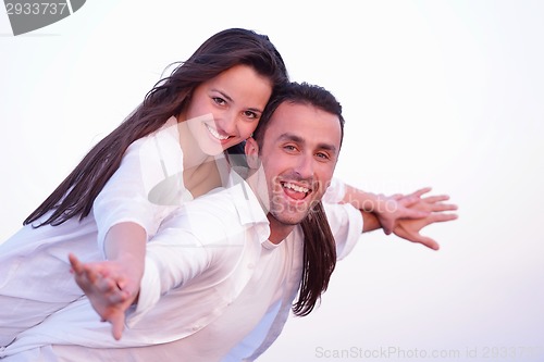 Image of young couple  on beach have fun