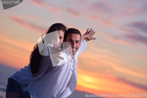 Image of young couple  on beach have fun