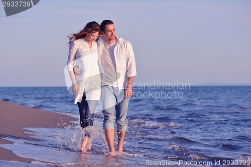 Image of young couple  on beach have fun