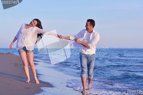 Image of young couple  on beach have fun