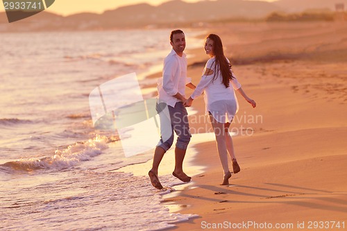 Image of young couple  on beach have fun