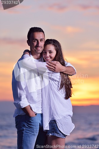 Image of young couple  on beach have fun
