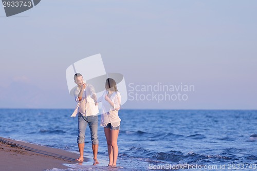 Image of young couple  on beach have fun