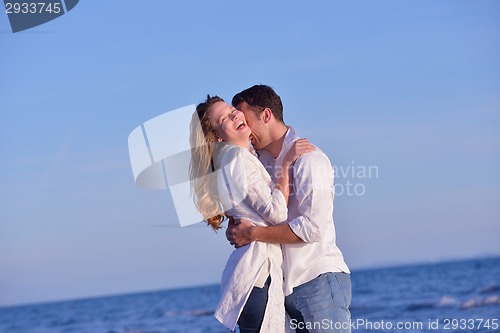 Image of young couple  on beach have fun
