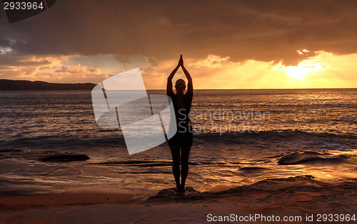 Image of Woman Tadasana  -  Mountain Pose  yoga by the sea at sunrise