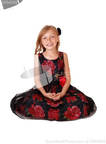 Image of Smiling girl sitting on floor.