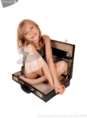 Image of Girl sitting in briefcase.