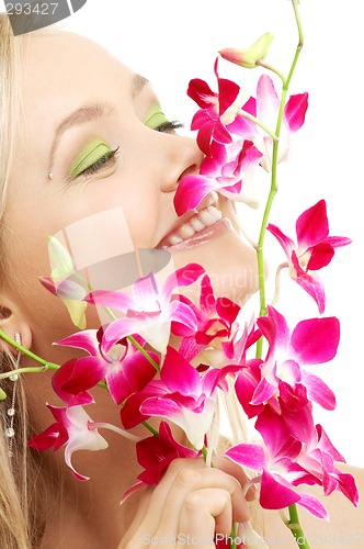 Image of happy blond with orchid