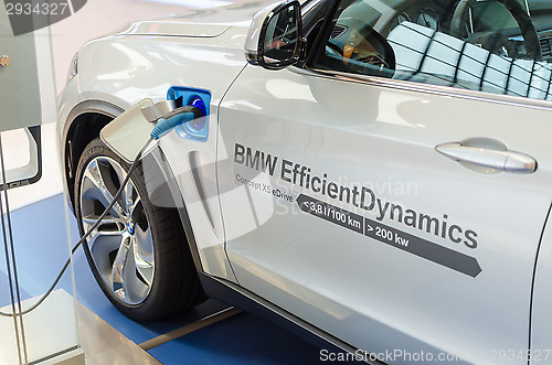 Image of New model of BMW x5 with hybrid engine at charging station