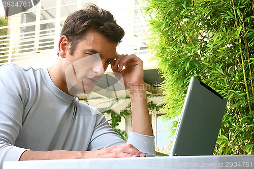 Image of young man and laptop