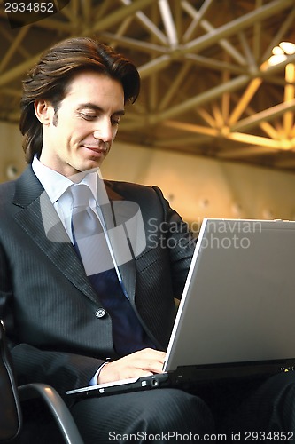 Image of businessman sitting in the airport b