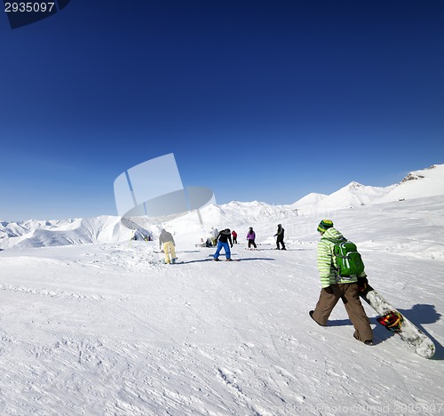 Image of Skiers and snowboarders on ski slope