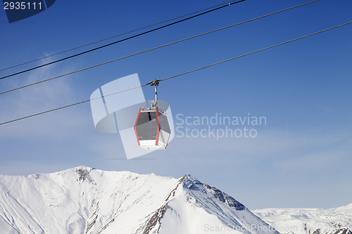 Image of Gondola lift and snowy mountains