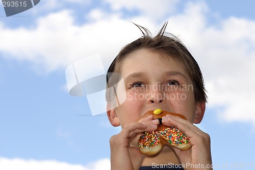Image of Boy biting into donut