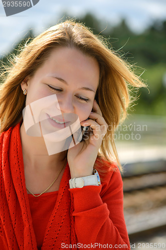 Image of Beautiful caucasian girl talking to phone