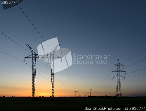 Image of Large transmission towers at sunset