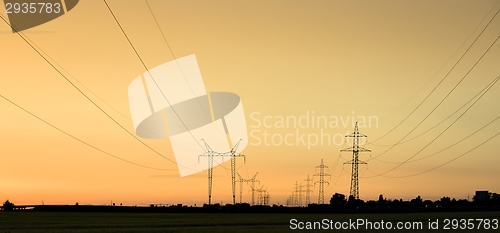 Image of Large transmission towers at sunset