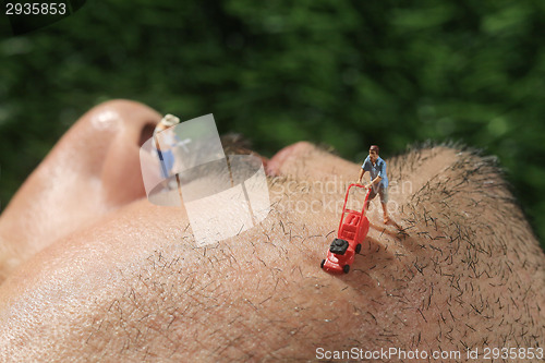 Image of Little People Mowing Hair off a Mans Face