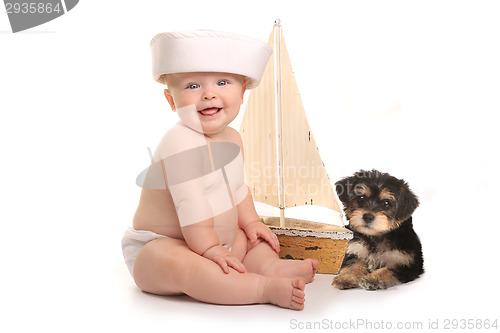 Image of Adorable Baby Boy With His Pet Teacup Yorkie Puppy