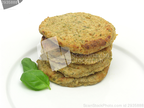 Image of potato dough cakes with basil lying upon another