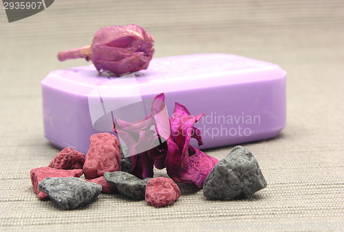 Image of Lilac soap with decoration articles on a  gray  background