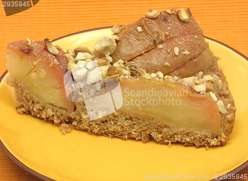 Image of One slice of a wholemeal apple cake on orange placemat