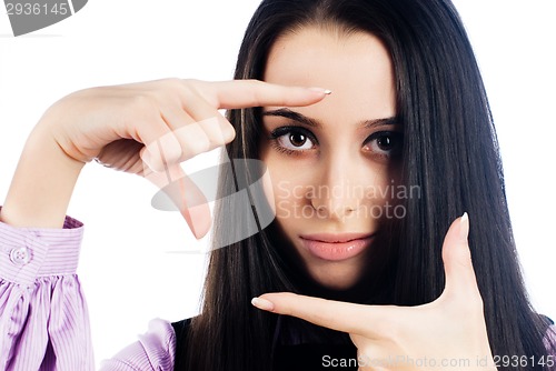 Image of Pretty girl with frame gesture. Focus on fingers