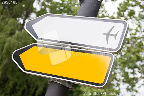 Image of Yellow and white arrow road sign.