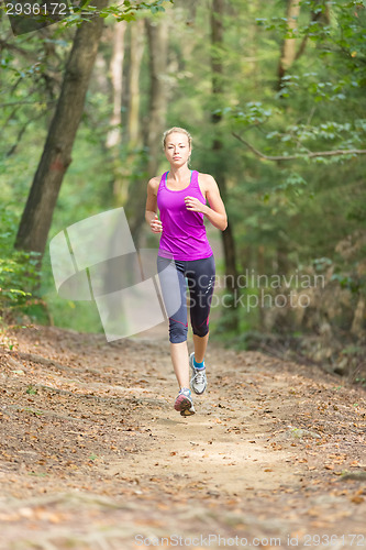Image of Pretty young girl runner in the forest. 