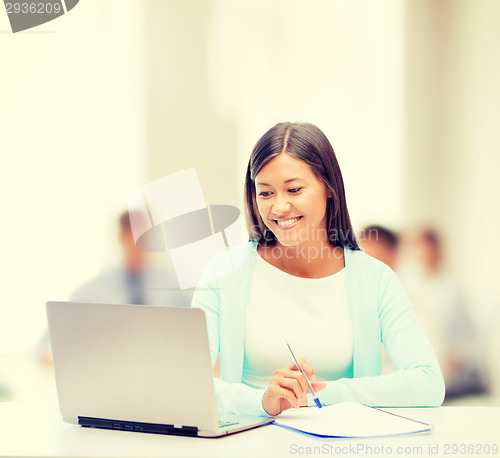 Image of asian businesswoman with laptop and documents