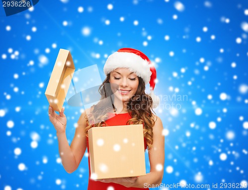 Image of smiling woman in santa helper hat with gift box