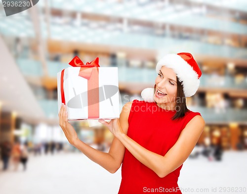 Image of smiling woman in red dress with gift box