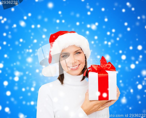 Image of smiling woman in santa helper hat with gift box