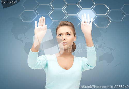 Image of smiling businesswoman working with virtual screen