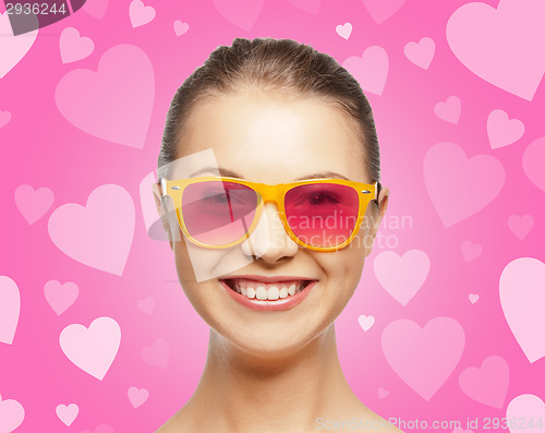 Image of smiling teenage girl in pink sunglasses