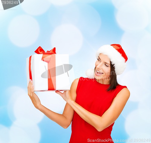 Image of smiling woman in red dress with gift box