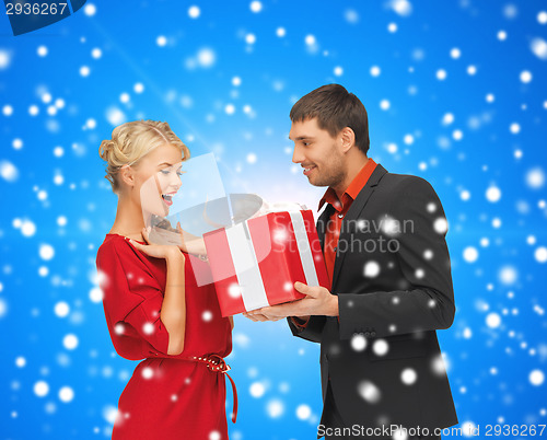 Image of smiling man and woman with present