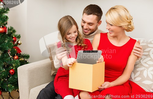 Image of smiling family with tablet pc