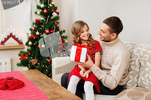 Image of smiling father and daughter looking at each other