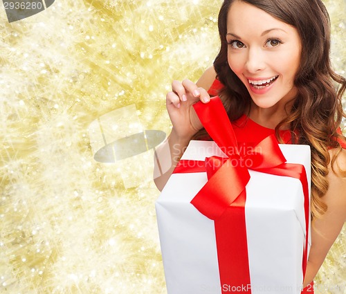 Image of smiling woman in red dress with gift box