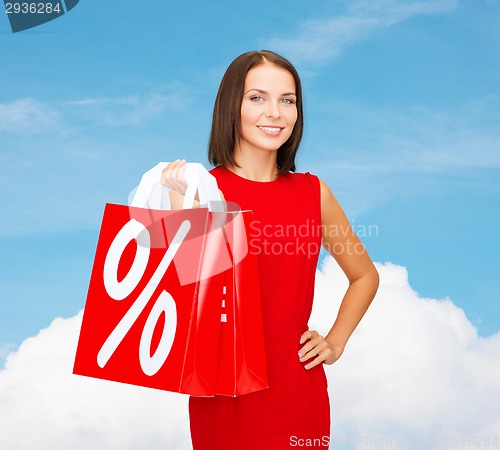 Image of woman in red dress with shopping bags