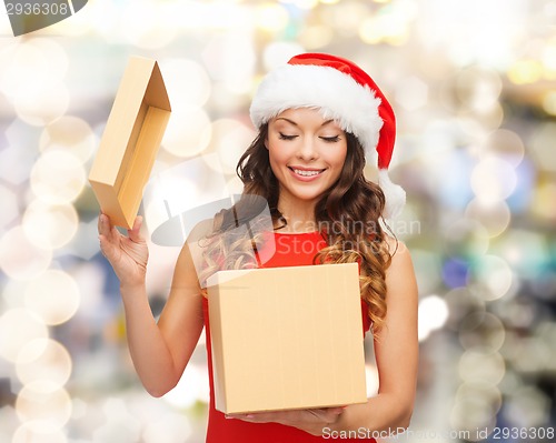 Image of smiling woman in santa helper hat with gift box