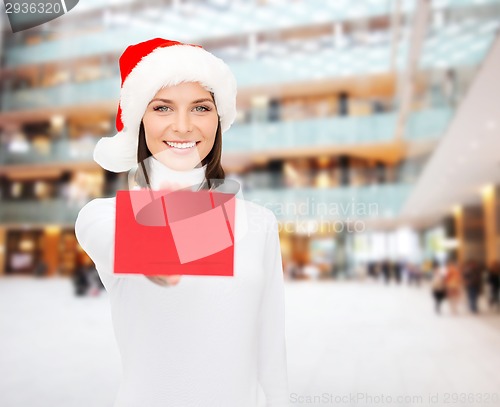 Image of woman in santa helper hat with blank red card