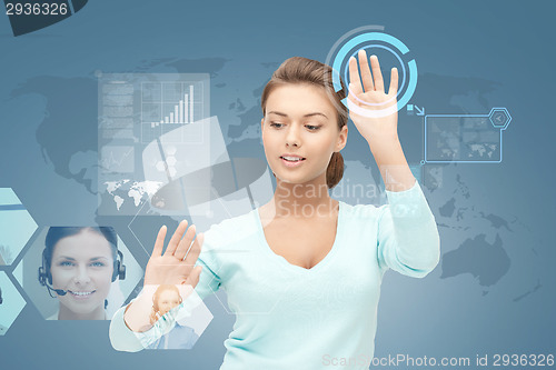 Image of smiling businesswoman working with virtual screen