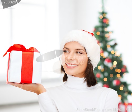 Image of smiling woman in santa helper hat with gift box
